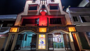 A multi-story building with a prominent entrance and signage for 'Baramunda Residence'.
