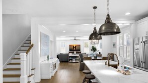A spacious kitchen with a marble countertop, wooden bar stools, and a large island. - 💙Walk 2 Beach-Community Pool-4BR Sand Dollar Beach Cottage🌊 (Miramar Beach)