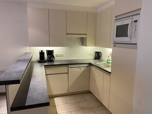 A modern kitchen with a dishwasher, a coffee maker, and a microwave. - Apartment Near Marina Nieuwpoort & Golf (Nieuwpoort)