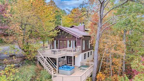 A cabin with a hot tub, deck, and stairs leading to the entrance. - Majestic Cabin Getaway • Epic Views, Hot Tub & Game Room • Family-Friendly (Gatlinburg)