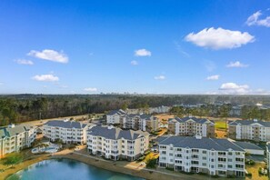 A residential area with multi-story buildings, a swimming pool, and a clear sky.