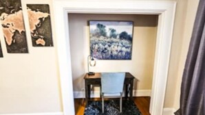 A room with a desk, chair, and a world map on the wall. - The Terrace (Charlotte)