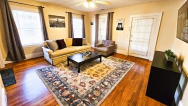 A living room with a sofa, a coffee table, and a rug. - The Terrace (Charlotte)