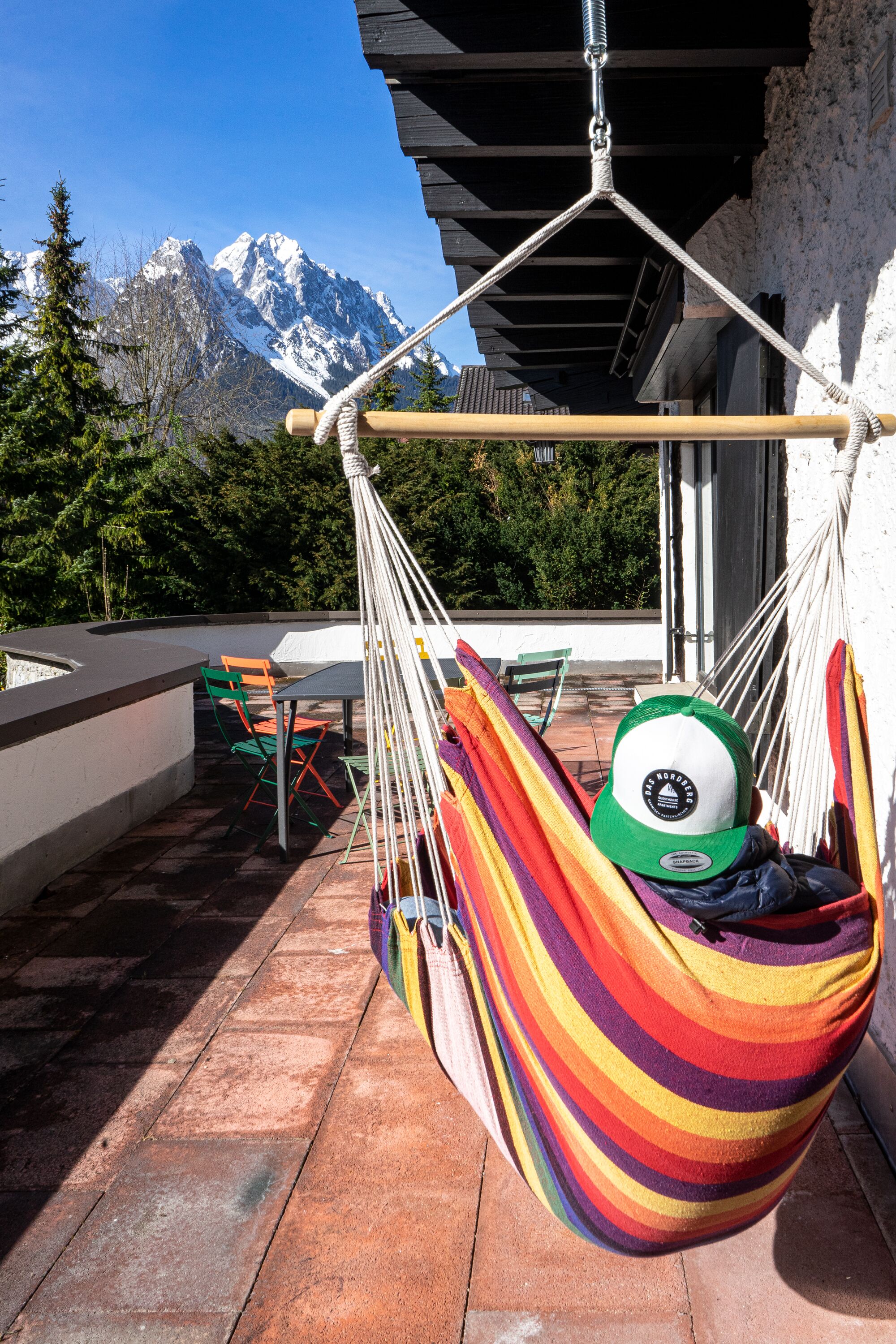 A hammock on a terrace with a mountain view.