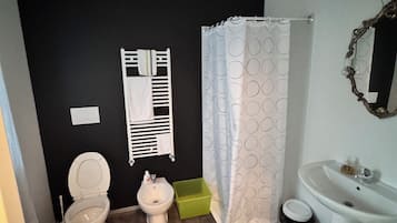 Een douche, een haardroger, een bidet, handdoeken
