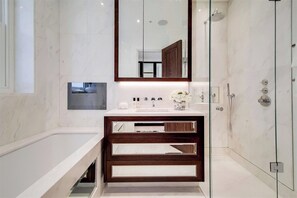 A modern bathroom with a large mirror, a bathtub, and a shower. - 2 Bedroom Flat With Balcony (London)