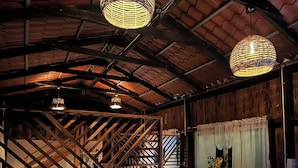 A rustic interior with exposed wooden beams and a sloped ceiling.