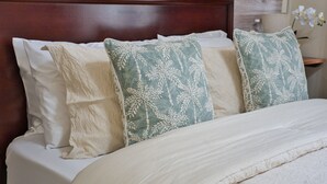 A neatly made bed with white linens and three decorative pillows with a leaf pattern. - F2 - Pool, Inverter, Gym, Pavilion, Wifi, Perfect for Kids - Ibex Meanwood! (Lusaka)