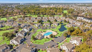 A residential area with houses, a swimming pool, and a golf course.