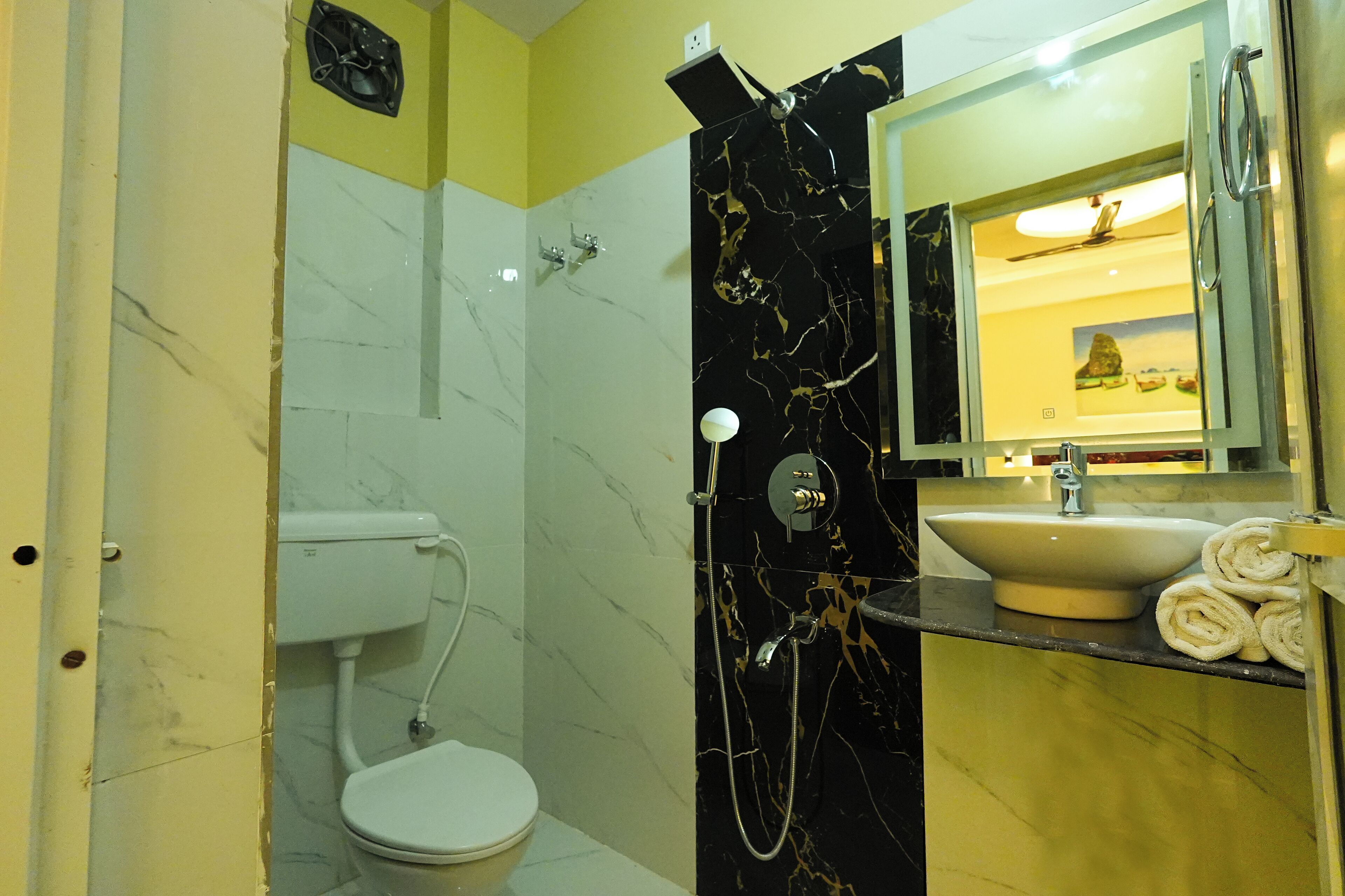 A bathroom with a toilet, a sink, and a shower.