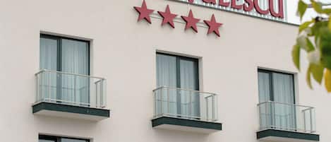 A hotel named "HOTEL CHITULESCU" with a sign featuring three stars and multiple balconies.