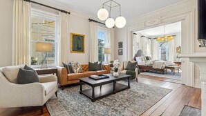 A spacious living room with a sofa, coffee table, and a fireplace. - Palazzo Sul Monte-Uno (Wilmington)
