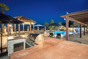 An outdoor patio with a barbecue grill, pool, and covered seating areas. - Scenic Luxury Oasis: Views, Pool, Spa, Game & Movie Rms (Bonita)