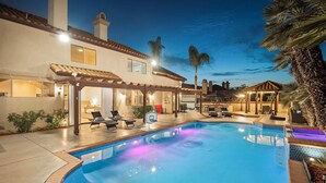 A swimming pool with lounge chairs and a covered patio area. - Scenic Luxury Oasis: Views, Pool, Spa, Game & Movie Rms (Bonita)