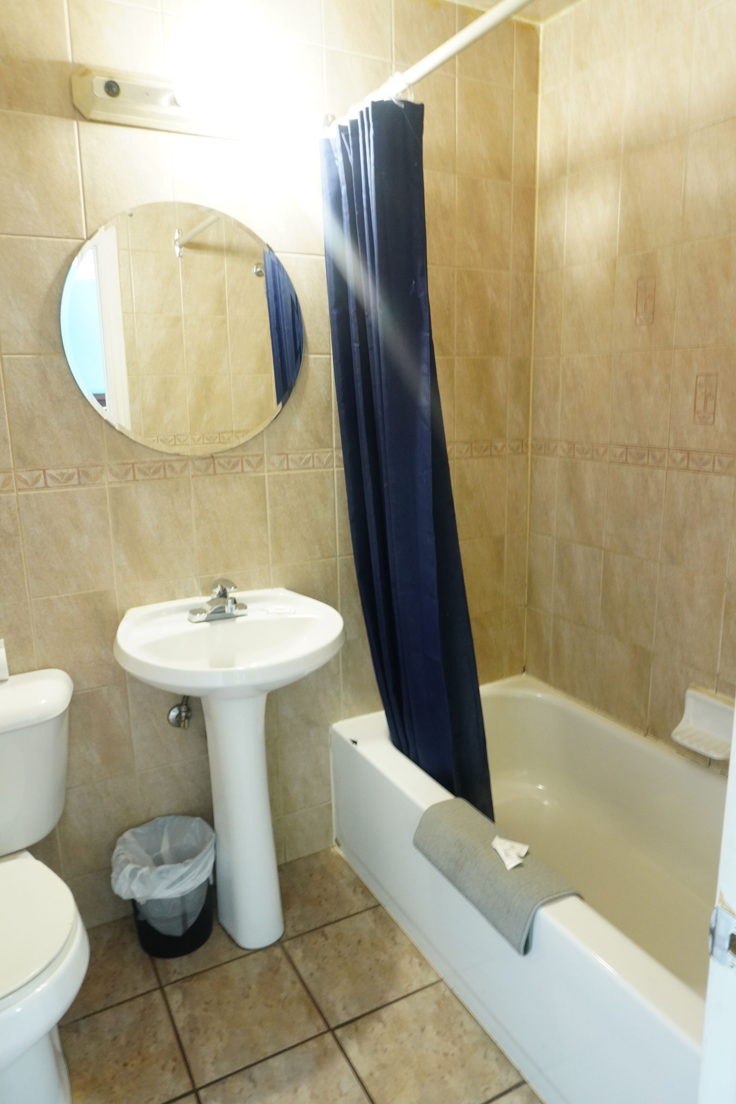 A bathroom with a sink, toilet, and bathtub.