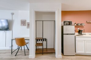 A modern kitchen with white cabinets, a white refrigerator, a microwave, and a coffee maker. - 5 min. to Lincoln's top attractions. King-size bed, kitchenette & outdoor space (Lincoln)