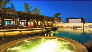 A pool area with a hot tub, lounge chairs, and a covered seating area with tables and chairs. - Private Jacuzzi w/  Ocean Views, Copala Quivira - 20% off F & B - 3 Bed (Cabo San Lucas)