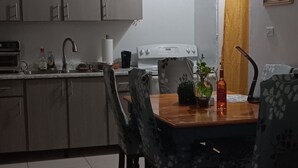 A dining area with a table, chairs, and a ceiling fan.