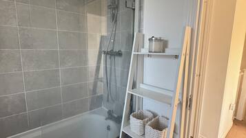 Shower, hair dryer, towels, toilet paper