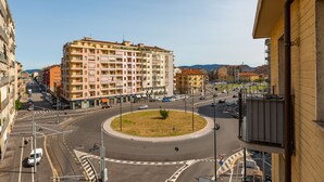 A multi-story building with a central courtyard, surrounded by roads and other buildings. - Sports Cave (Torino)