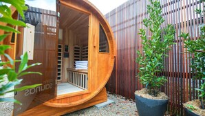 A wooden, circular structure with a bench and towels, surrounded by a wooden fence and potted plants. - The Rocks - Olive Retreat (Bright)