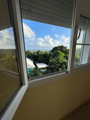 Guests can enjoy a serene view of the lush landscape from the comfort of their room.