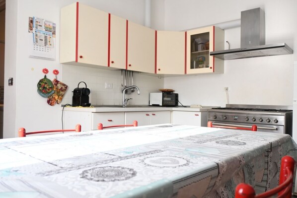 A kitchen with a stove, oven, and cabinets.