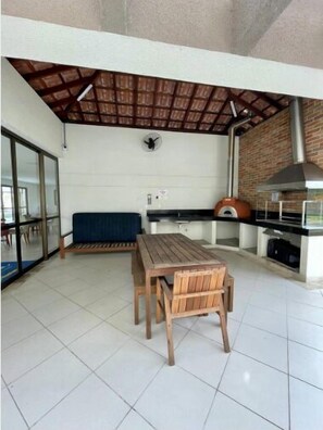 Relax in this serene outdoor space with a seating area and modern kitchen.