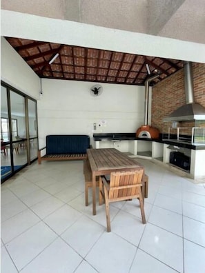 Relax in this serene outdoor space with a seating area and modern kitchen.