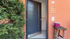 A door leading to a room with a sign indicating 'Room Milano Venezia Verona.' - Room 'Relais Olivi Superior Verona' with Lake View, Wi-Fi and Air Conditioning (Costermano sul Garda)