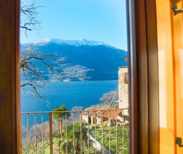 A balcony with a view of a lake and mountains.