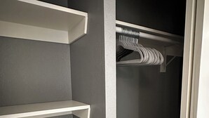 A walk-in closet with grey walls, white shelving units, and a hanging rod. - ~Remodeled Mtn View Condo, Hot Tub, Modern, Fast WiFi~ (Boulder)