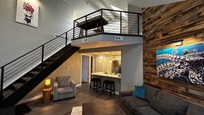 A multi-level living space with a staircase, a dining area, and a large abstract painting on the wall. - ~Remodeled Mtn View Condo, Hot Tub, Modern, Fast WiFi~ (Boulder)