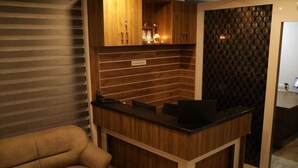 A modern kitchen with wooden cabinets, a countertop, and a patterned wall.
