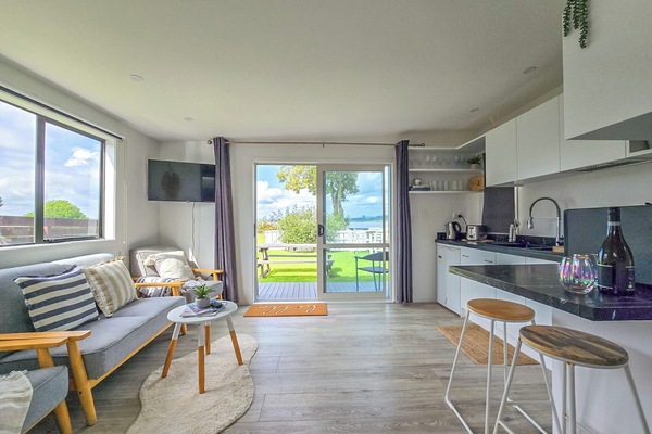 Open plan living and kitchen area - open the doors to the Waterview!