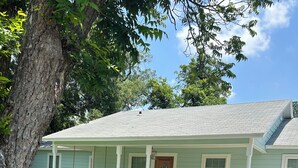 A light blue house with a porch, a front door, and a mailbox. - Gorgeous quiet and cozy 3 bedroom/ 2 bathroom home awaits you! (Uvalde)
