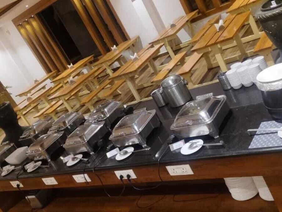 Una mesa de madera con varios recipientes y utensilios para un bufé.
