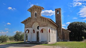 A church with a bell tower and a small entrance. - Apartment in Piticchio with Pool and BBQ (Arcevia)