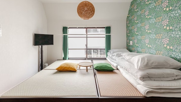 A room with a bed, a TV, and a window with curtains. - CROWN Asakusabashi (Tokyo)