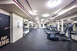 A gym with treadmills, elliptical machines, and free weights.