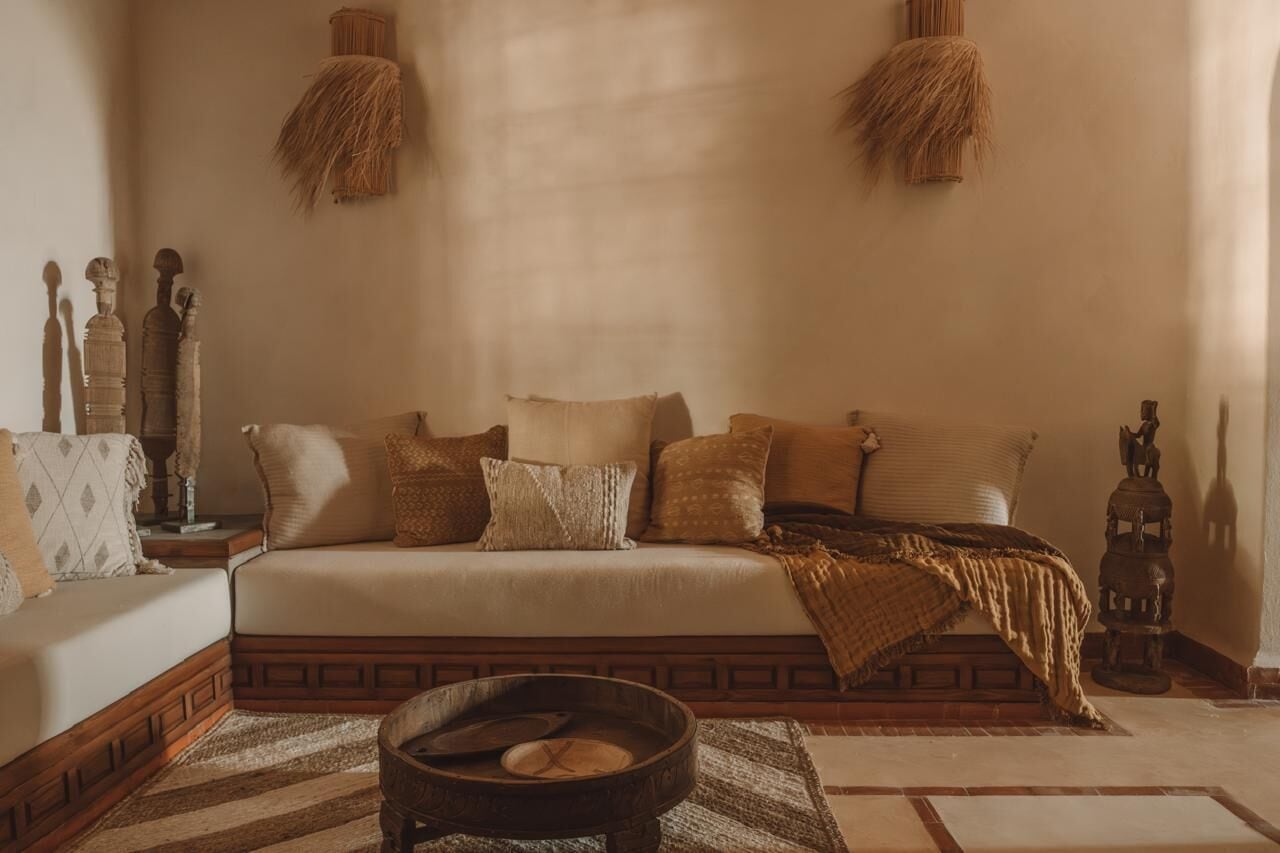 A cozy room with a sofa, a small table, and decorative items.