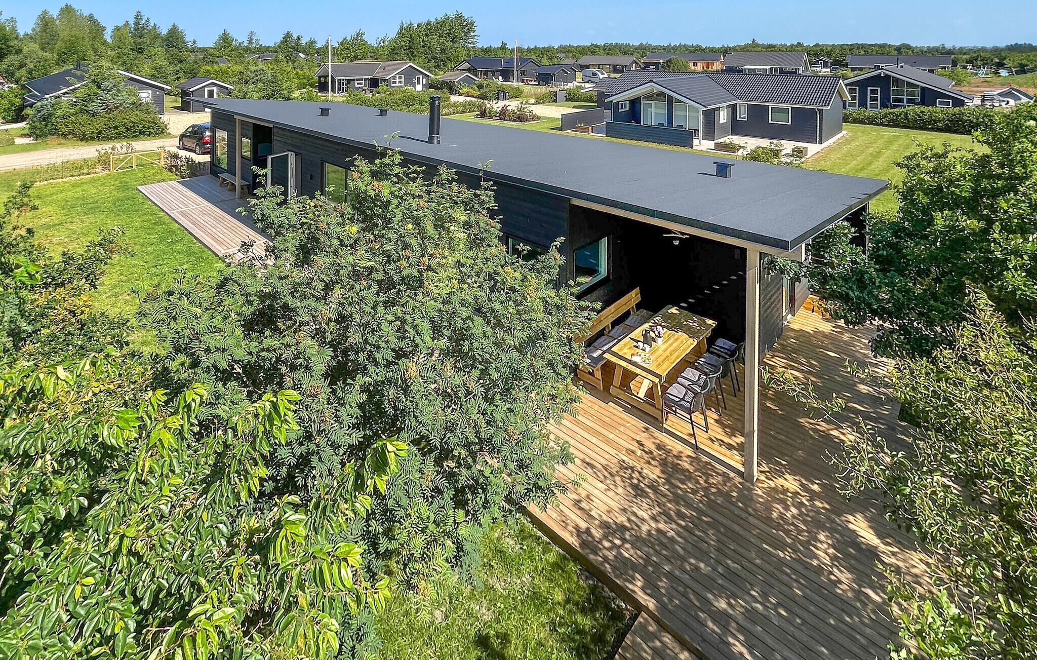 A modern house with a large deck and a covered outdoor area.