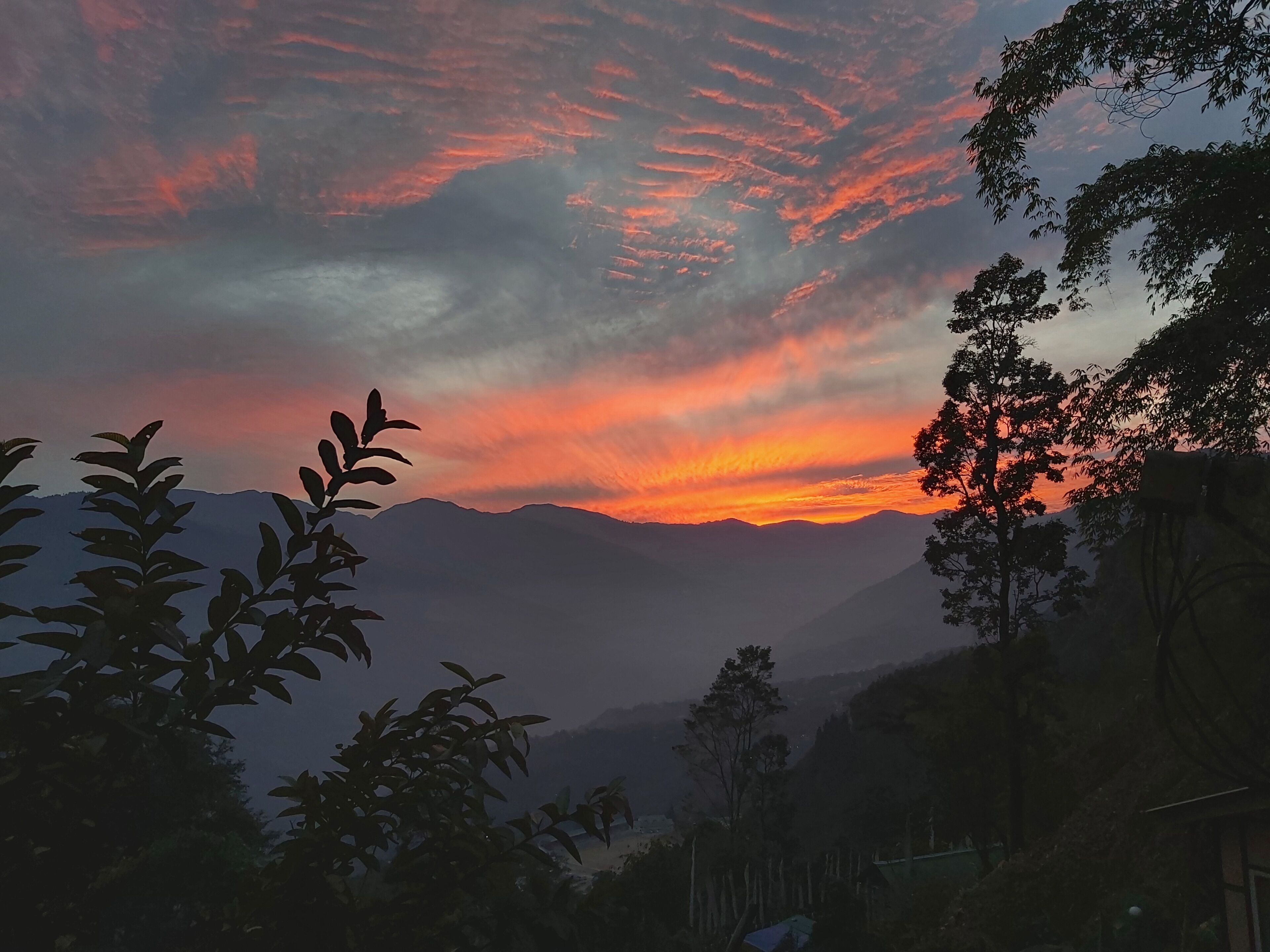 A mountainous landscape with a sunset.