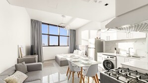 Ein modernes Apartment mit Essbereich, Küche und Wohnbereich.