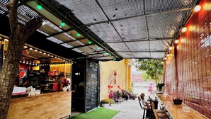 An indoor cafe with a wooden counter, bar area, and seating. - Noibai Sunflower Hotel (Hanoi)