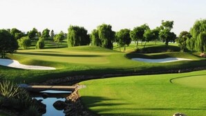A well-maintained golf course with sand bunkers, water hazards, and a variety of trees. - Noibai Sunflower Hotel (Hanoi)