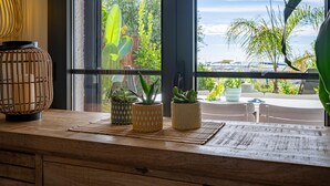 A wooden table with potted plants and a hanging light fixture.