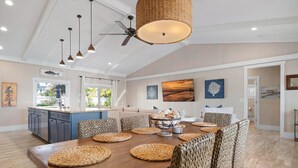 A spacious kitchen with a large island, pendant lights, and a ceiling fan. - Cocktails and Dreams by Beach Boutique Rentals (Holmes Beach)