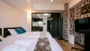A hotel room with two beds, a TV, and a kitchenette. - Randor Residence Tokyo Annex (Tokyo)