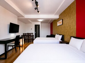 A hotel room with two beds, a desk, a chair, a television, and a door. - Randor Residence Tokyo Annex (Arakawa-ku)